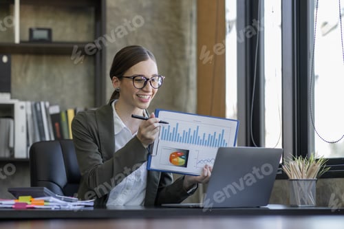 Preview: Young attractive Freelancer business asian woman talking about sale report in video call conference