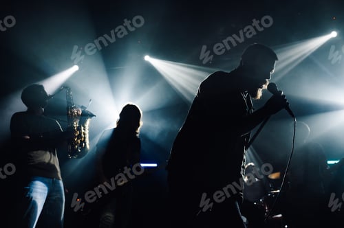 Preview: Band performing live music on stage with spotlights