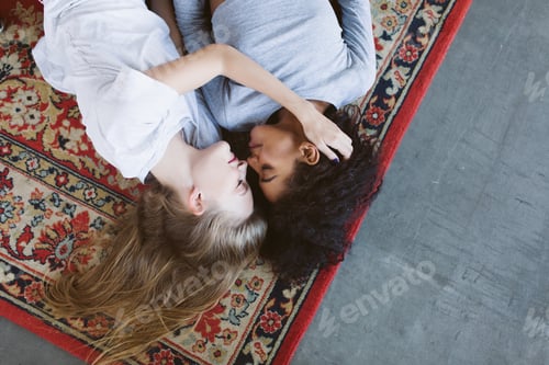 Preview: Young beautiful woman with blond hair and african american woman