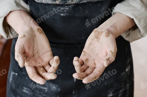 Preview: Open palms of young skilled craftswoman in apron standing in front of camera