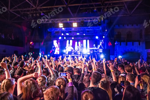 Preview: The silhouettes of concert crowd in front of bright stage lights