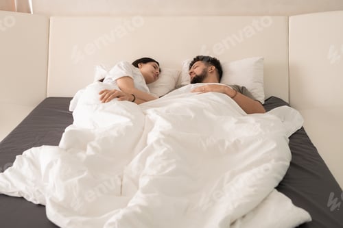 Preview: Contemporary young just married couple sleeping in bed