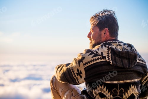 Preview: Adult man sitting outdoor and looking landscape - travel and nature lifestyle concept