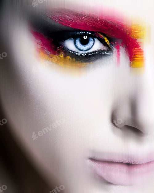 Preview: Close-up of a person's face with striking colorful makeup emphasizing one eye.