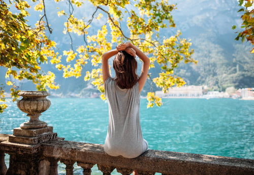 Preview: Young woman relaxing on beautiful Garda lake