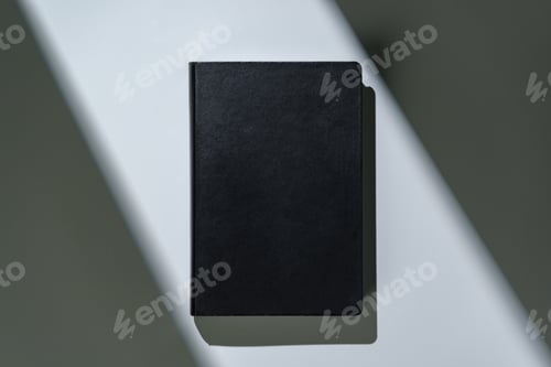 Preview: Black notepad with hard cover on gray background