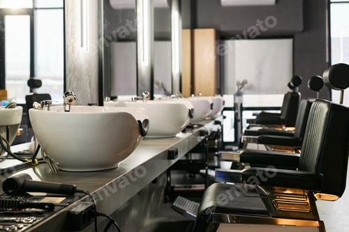 Preview: Empty Barbershop Interior Featuring Modern Barber Chairs and Wash Basins