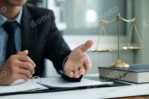 Preview: Male lawyer or judge working with Law books, gavel, report the case on table in modern office.