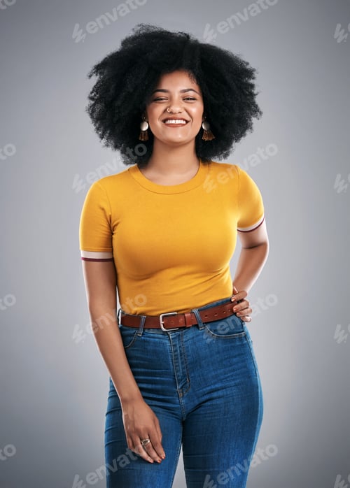 Preview: Studio shot of an attractive young woman posing against a grey background