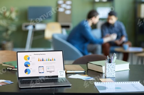Preview: Laptop screen with financial data and variety of supplies of office worker