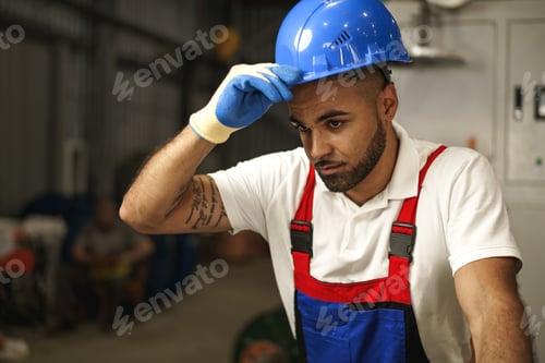 Preview: Portrait of young tired african american workman in cable production plant