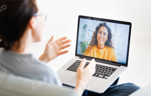 Preview: Woman Video Conferencing with Friend on Laptop Indoors