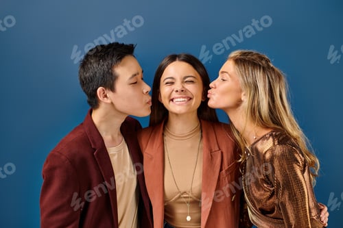 Preview: adorable interracial teenage boy and girl kissing their jolly friend in cheek, friendship day