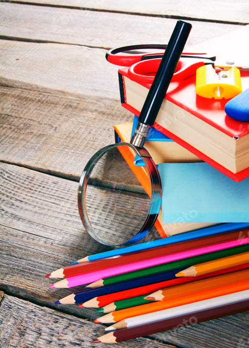 Preview: School tools. On wooden background.