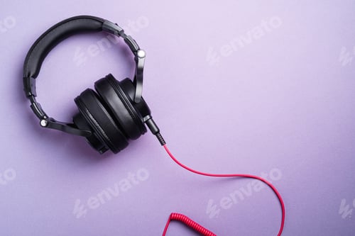 Preview: Classic black wired headphones on violet minimal background