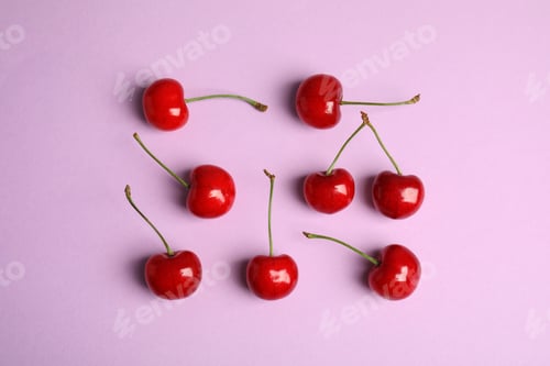 Preview: Many ripe sweet cherries on lilac background, flat lay
