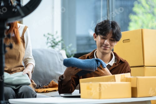 Preview: Couple start up small business owner. Couple sell clothes product online live streaming at home.