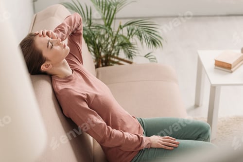 Preview: Woman Relaxing on Couch at Home