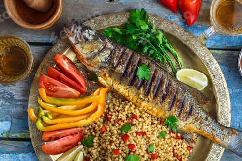 Preview: Close view of grilled sea bass with vegetables and ptitim, middle eastern cuisine