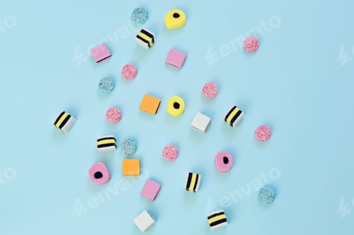 Preview: Colourful jelly candy scattered on blue background, abstract background concept.