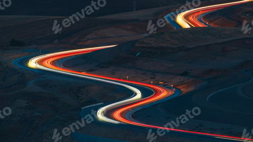 Preview: Car lights at night on the mountain pass winding road