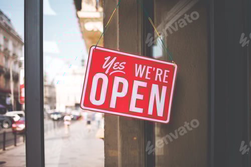 Preview: yes we're open sign on the glass of the doors in store. welcome sign at the store