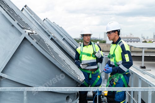 Preview: Engineers inspecting HVAC cooling systems on rooftop