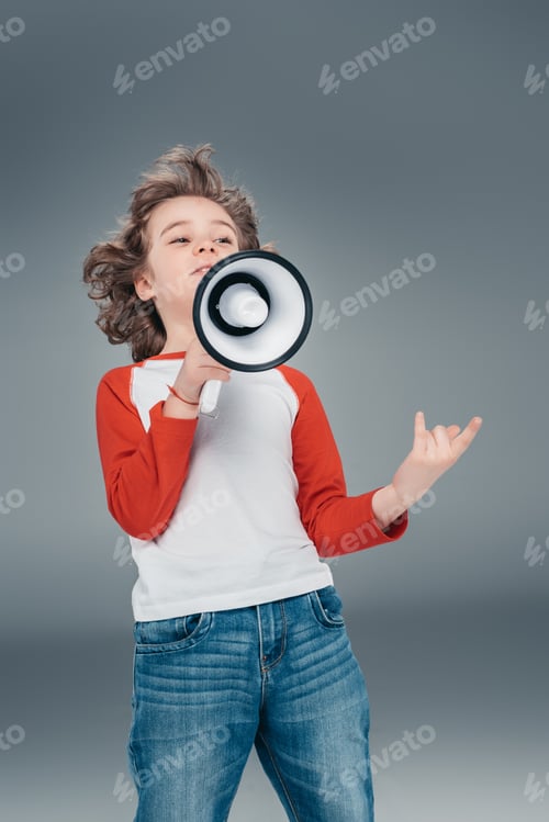 Preview: Boy using loudspeaker isolated on gray