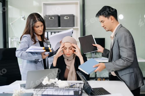 Preview: Furious Asian businesspeople arguing strongly after making a mistake at work in office