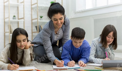 Preview: Pupil boy and girls drawing together with teacher