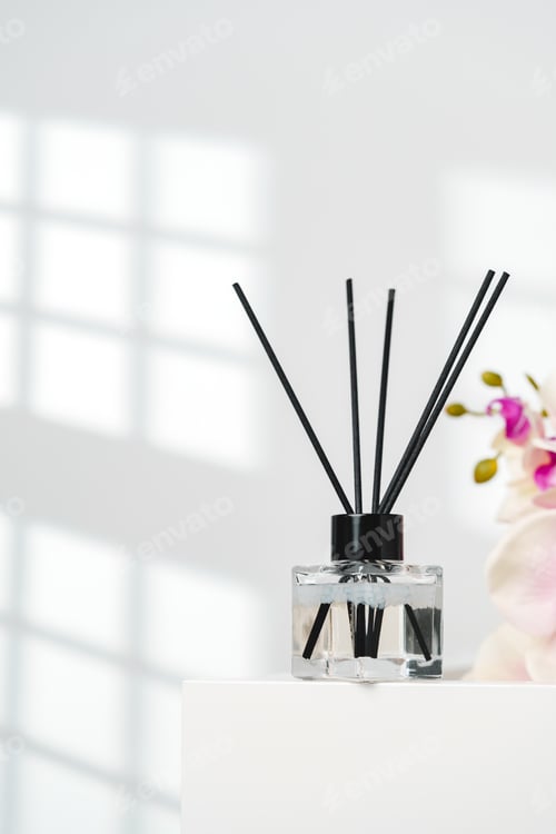 Preview: Elegant Reed Diffusers Beside Blooming Orchids in a Bright Interior Setting