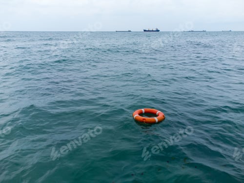Preview: Top view of lifebuoy in the sea. Life ring floating in a sea.