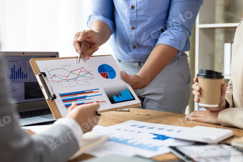 Preview: Business people discuss marketing growth chart and make business plan.