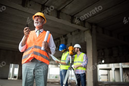 Preview: Engineer and construction site manager dealing with blueprints and plans