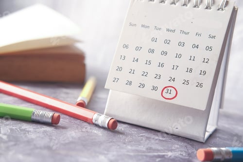Preview: deadline concept with red mark on calendar date with book and pencils on table