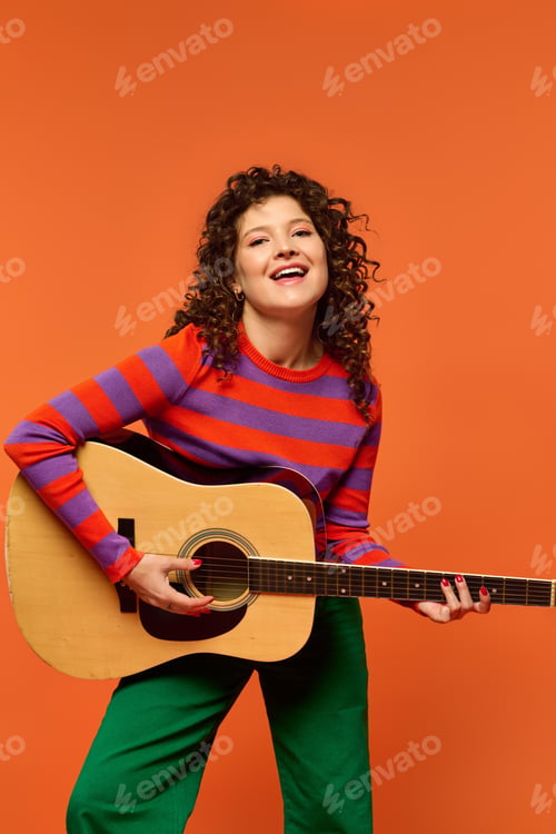 Preview: Curly girl strumming on orange