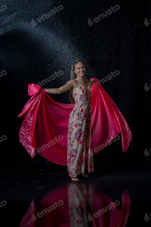 Preview: Sexy woman with wet hair wearing a flower-patterned dress and posing under the water splash