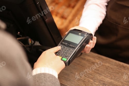 Preview: Woman using payment terminal at shop, closeup