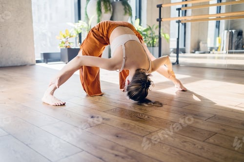 Preview: Woman Practicing Yoga in Light-Filled Studio