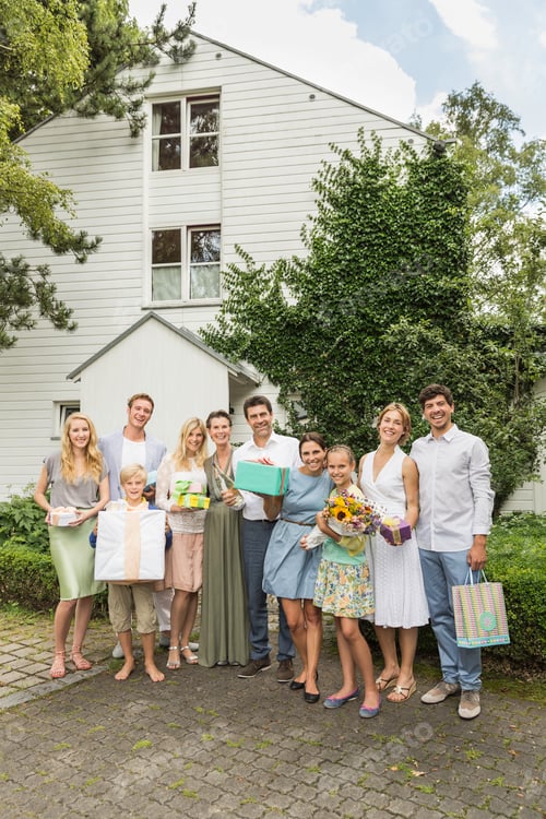 Preview: Portrait of three generation family with birthday gifts in garden