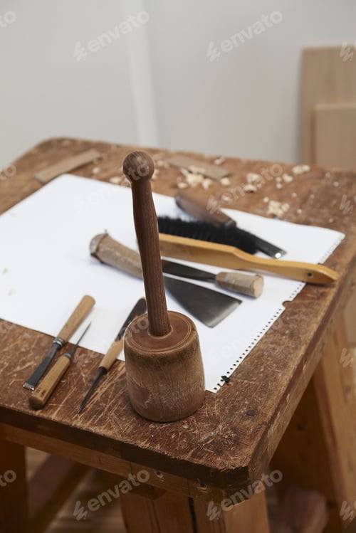 Preview: Chisel tools and paper on wooden board