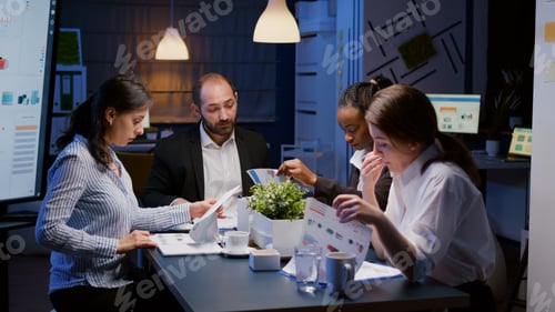 Preview: Diverse multi ethnic teamwork brainstorming company ideas analyzing financial strategy paperwork