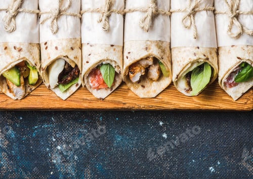 Preview: Tortilla wraps with different fillings on dark grey concrete background