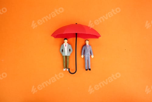 Preview: two miniature people under an umbrella.