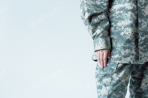 Preview: Cropped view of woman in military uniform standing isolated on grey