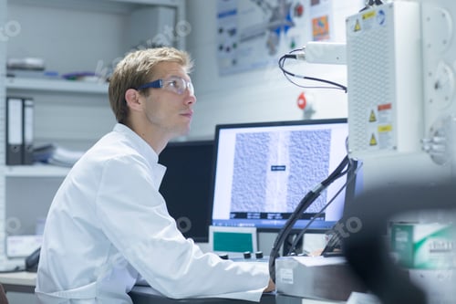 Preview: Scientist analyzing data on a computer in a modern laboratory.