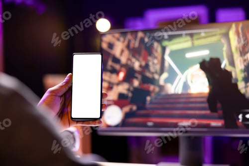 Preview: Man texting friends on isolated screen phone while playing videogame