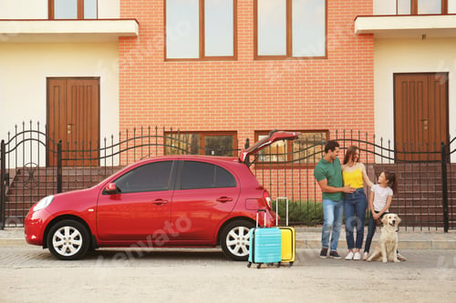 Preview: Happy family with their dog near car on street