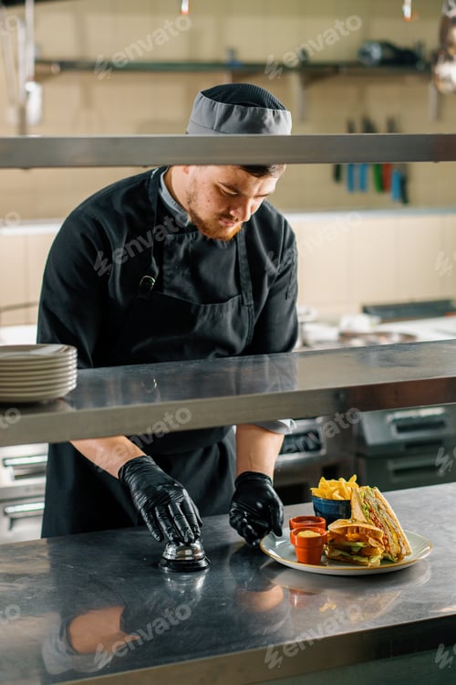 Preview: Professional kitchen the hotel chef makes beautiful presentation of club sandwich French fries