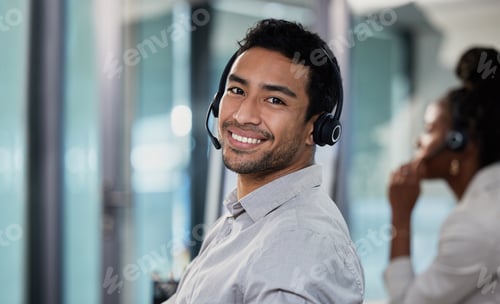 Preview: Shot of a handsome young customer service agent sitting in the office and wearing a headset